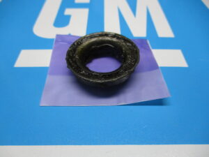 Closeup view of a black bearing placed on a blue surface