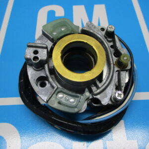 A closeup view of a component part placed on a blue surface